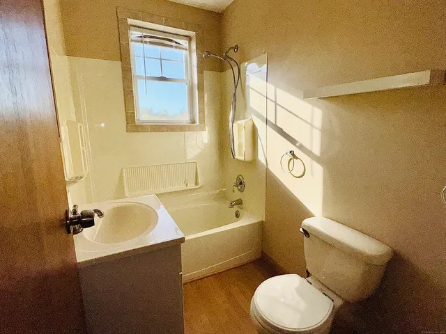 a bathroom with a sink mirror bathtub and toilet