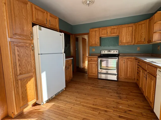 a kitchen with stainless steel appliances a refrigerator and a stove top oven