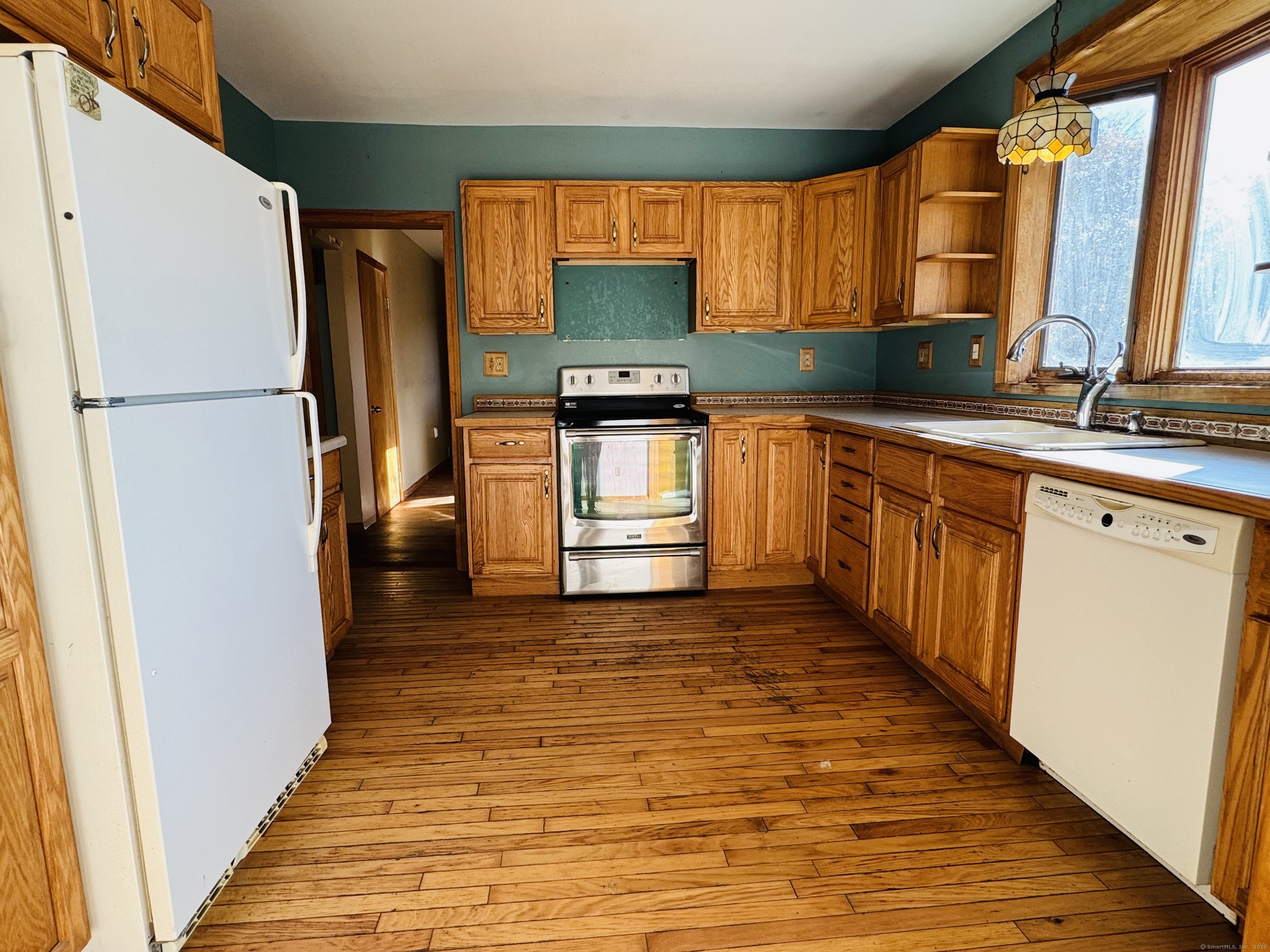 104 Cemetery Road Vernon, CT 06066 - Photo 5 of 28 a kitchen with granite countertop a refrigerator and a sink