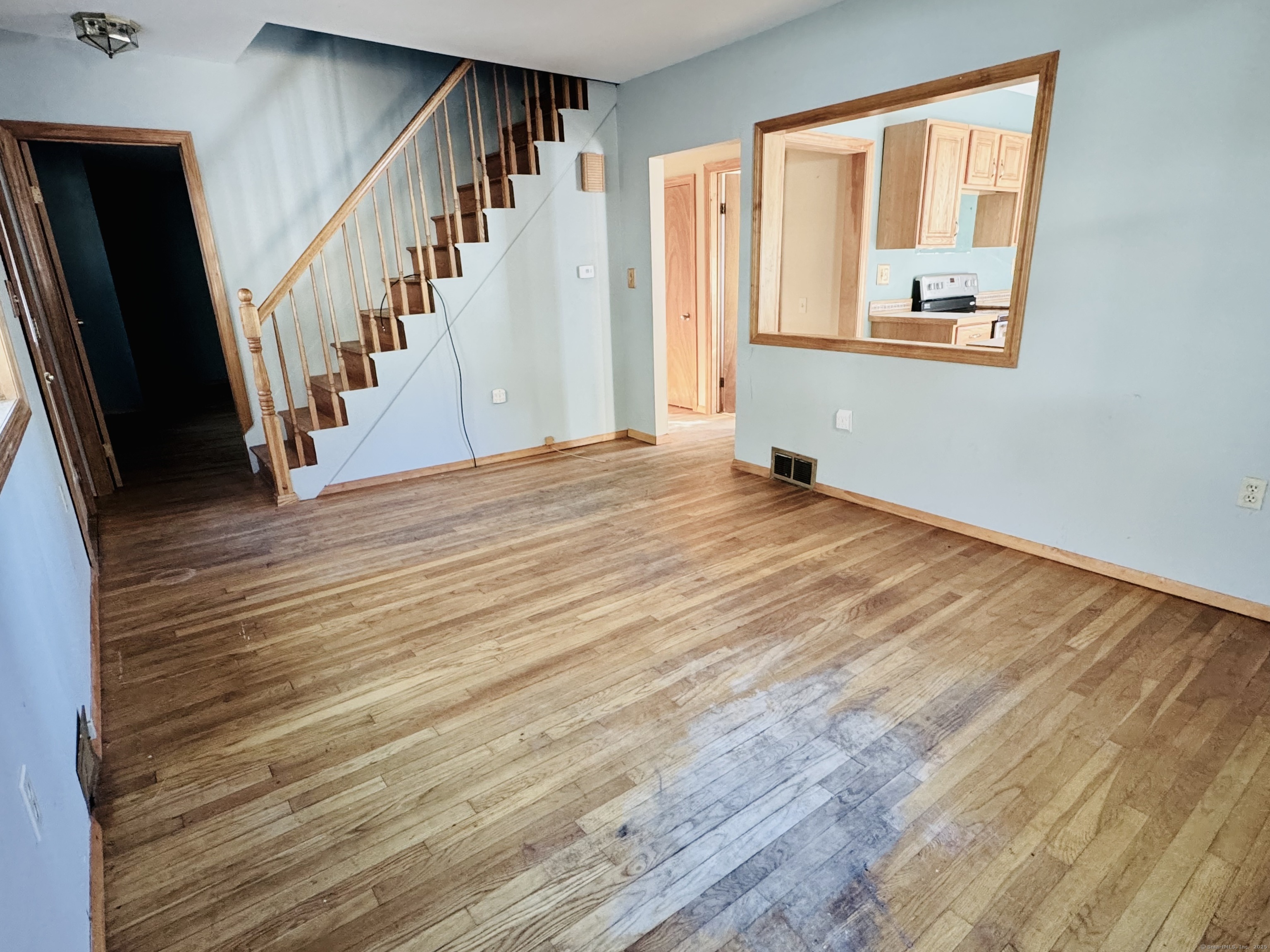 104 Cemetery Road Vernon, CT 06066 - Photo 8 of 28 a view of an empty room with wooden floor and stairs