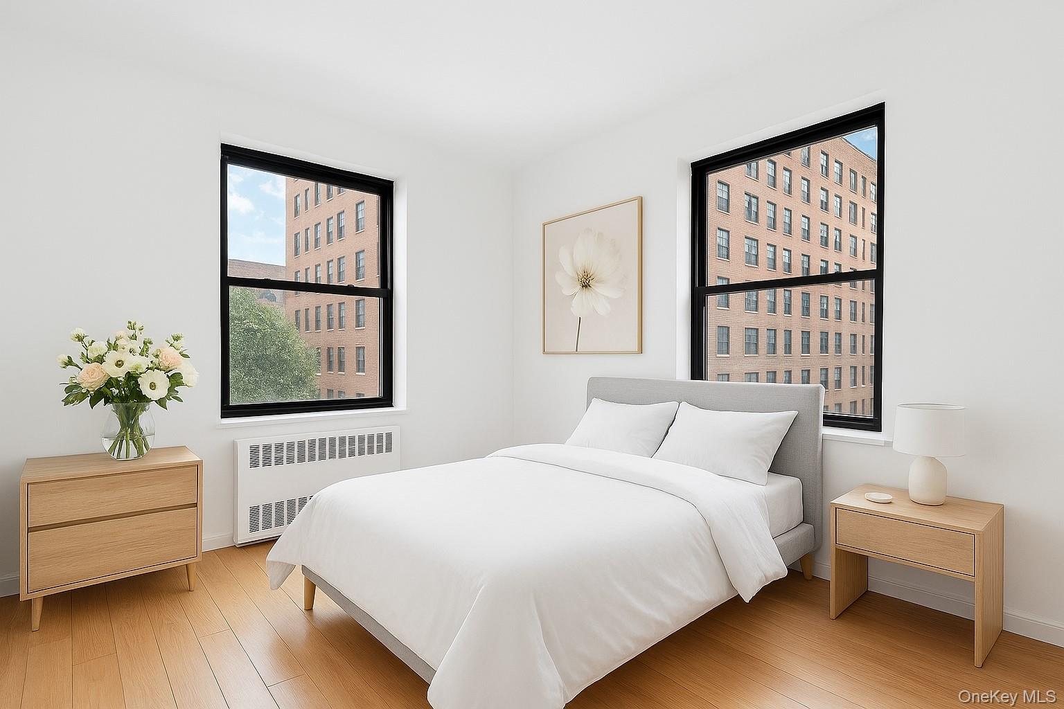 99-32 66th Road, Unit 5B Queens, NY 11374 - Photo 6 of 27 Bedroom featuring radiator and light wood finished floors