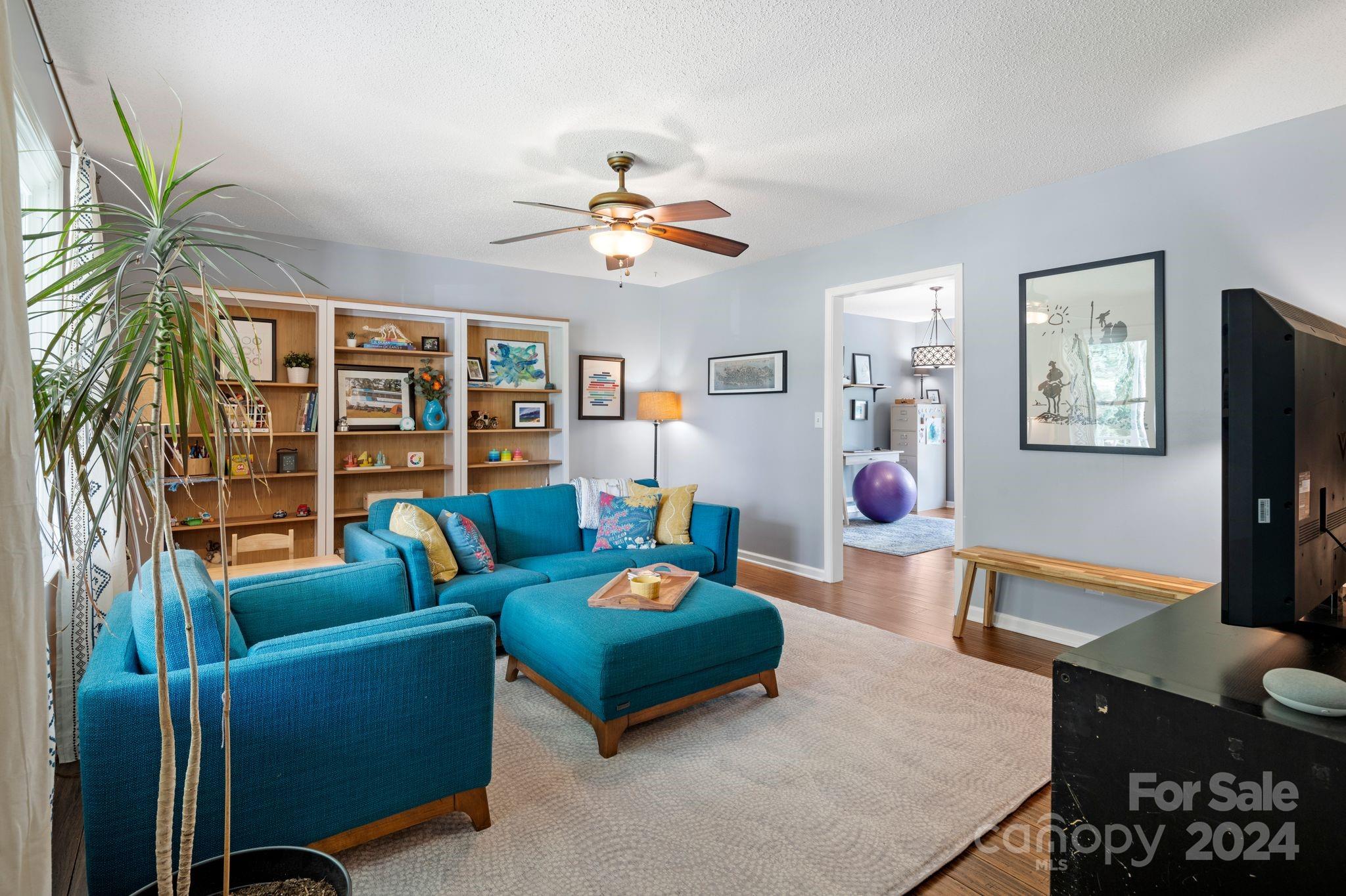 9 Mountain View Drive Arden, NC 28704 - Photo 3 of 19 a living room with furniture a flat screen tv and a table