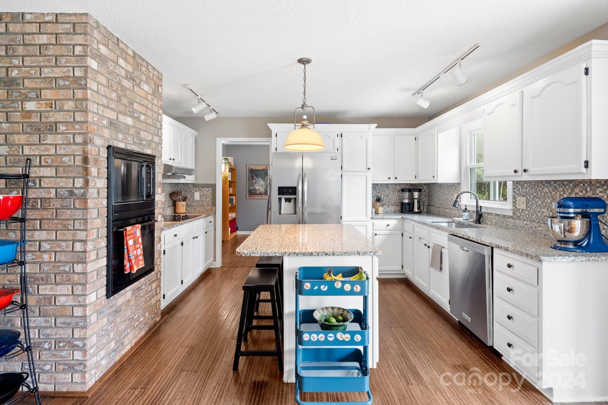 9 Mountain View Drive Arden, NC 28704 - Photo 4 of 19 a large kitchen with stainless steel appliances granite countertop a lot of counter space and wooden floor