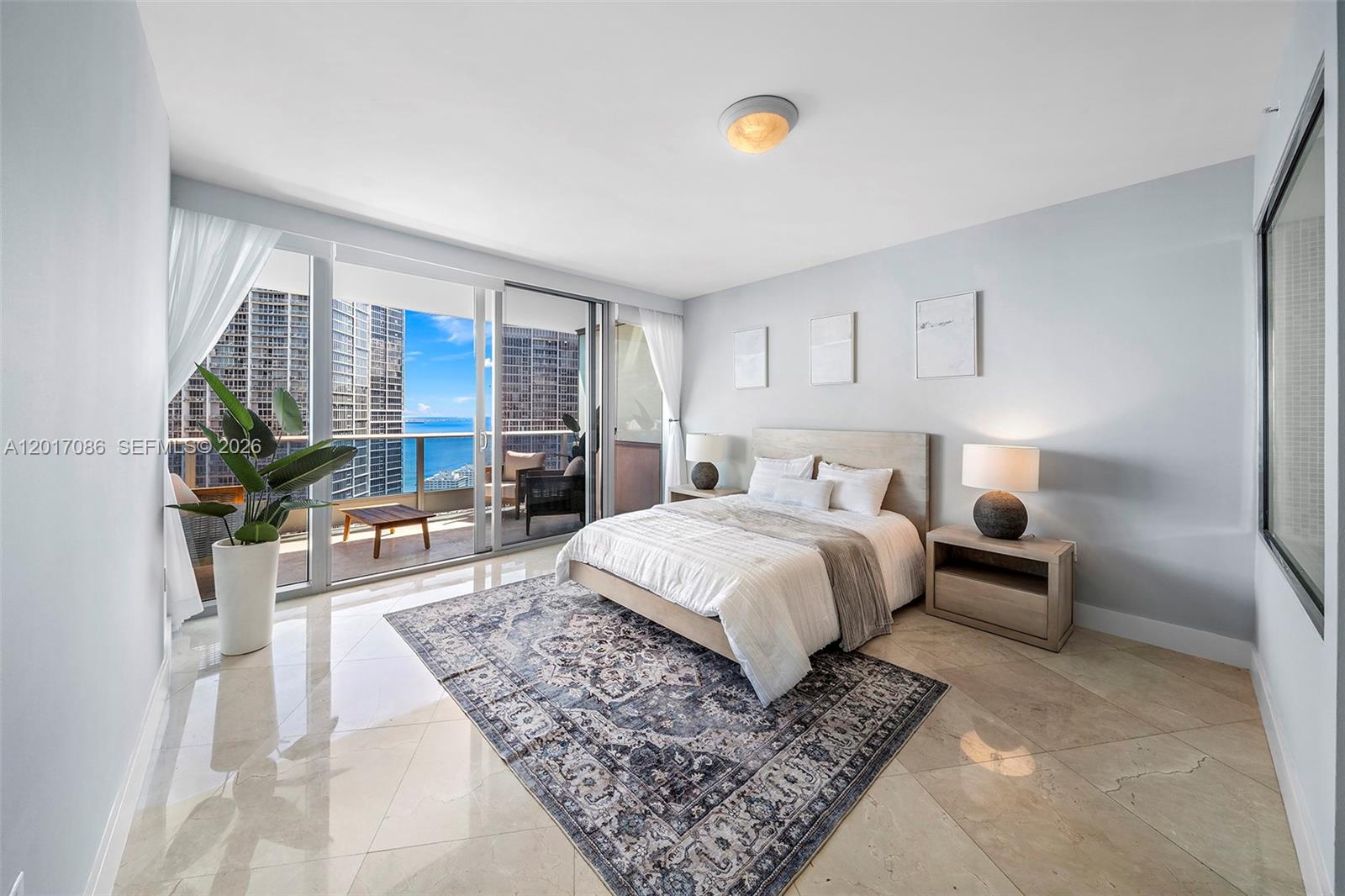 200 Biscayne Blvd Way, Unit 4308 Miami, FL 33131 - Photo 16 of 31 a bedroom with a large bed and a couch