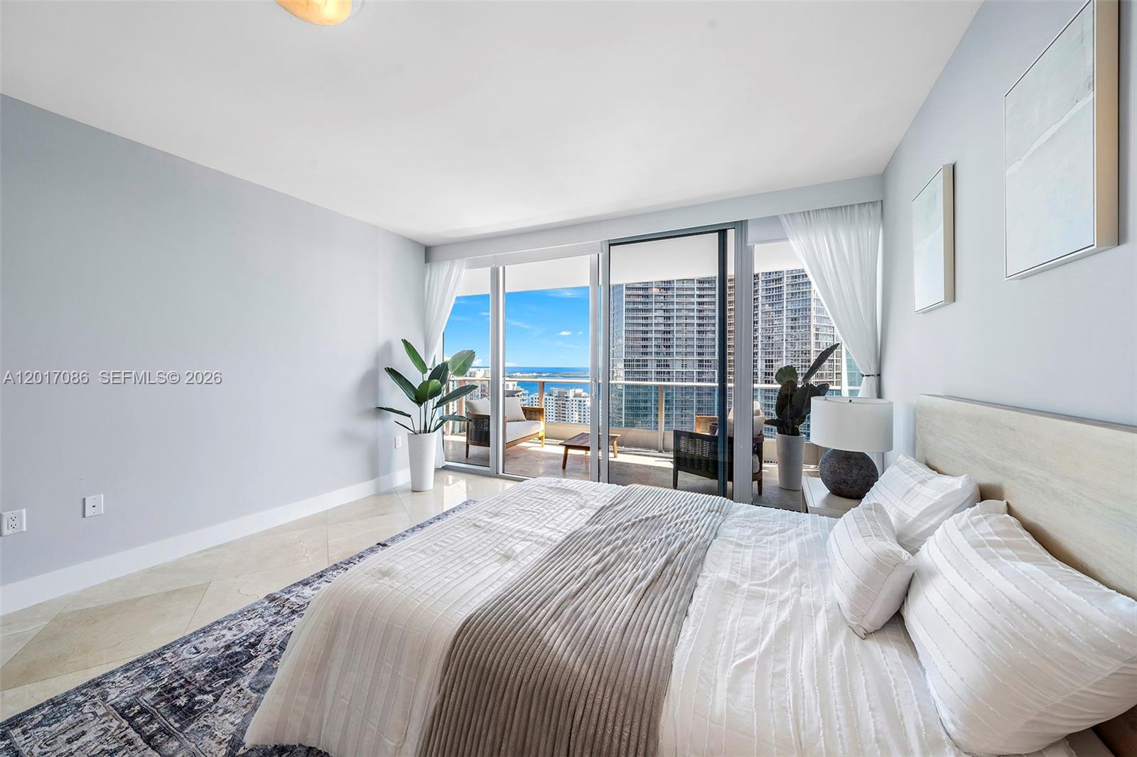 200 Biscayne Blvd Way, Unit 4308 Miami, FL 33131 - Photo 17 of 31 a bedroom with a large bed and a large window