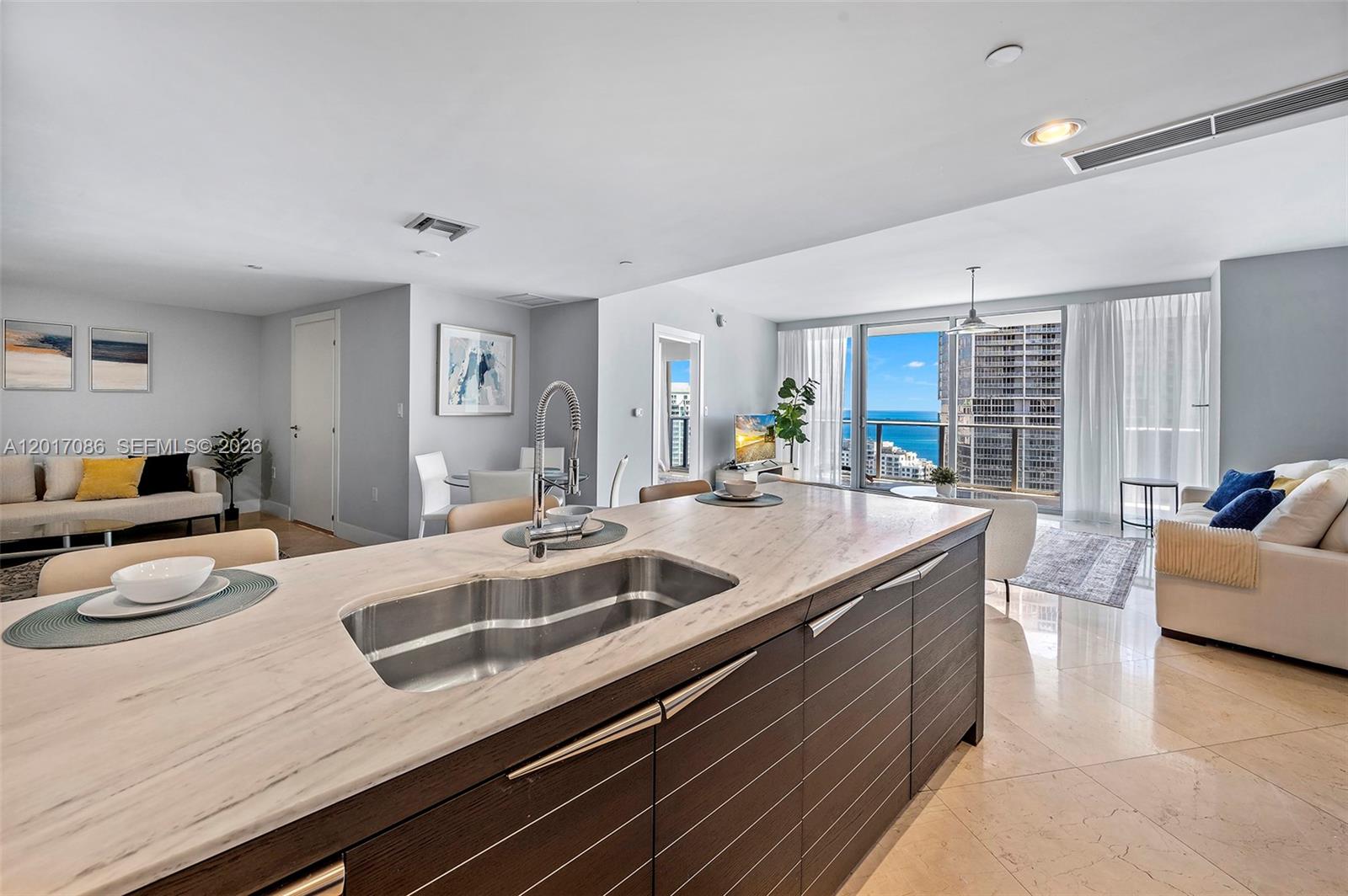 200 Biscayne Blvd Way, Unit 4308 Miami, FL 33131 - Photo 9 of 31 a view of kitchen island a sink and living room