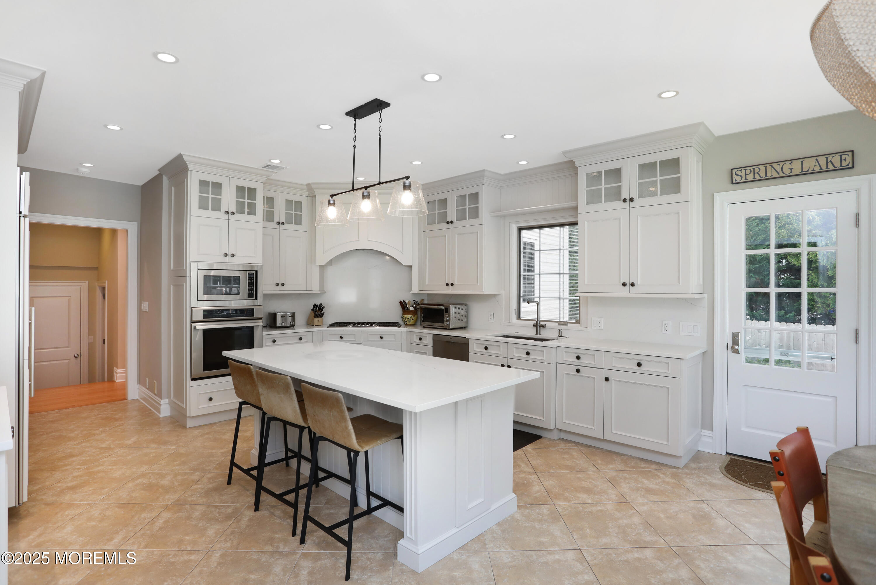 38 Vroom Avenue Spring Lake, NJ 07762 - Photo 5 of 15 a large kitchen with kitchen island a dining table and chairs