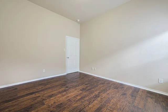 a spacious bathroom with a double vanity sink a mirror and a bathtub
