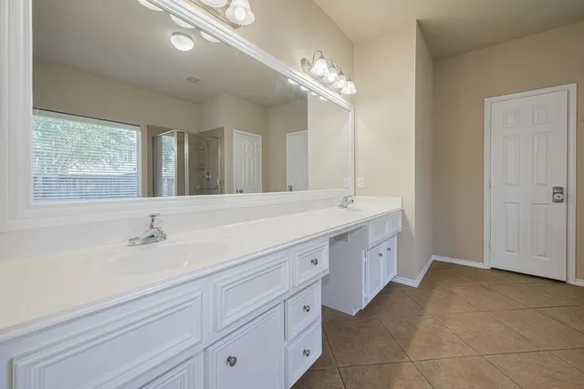 an empty room with wooden floor & closet area