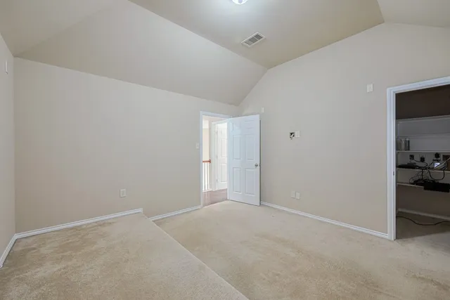 a view of walk in closet with empty racks