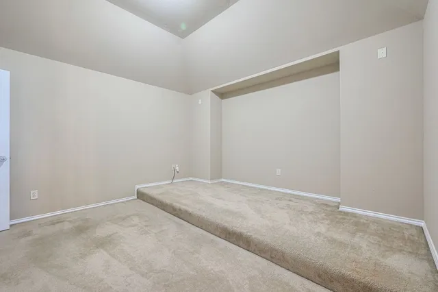 a view of a house with a big yard plants and large tree