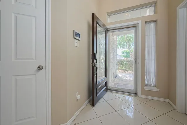 a view of an empty room with a fireplace and a window