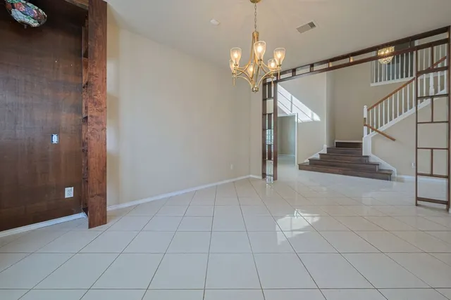 a view of a electric appliances in kitchen and empty room with wooden floor