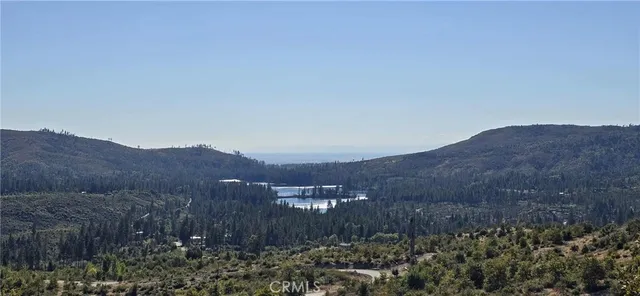 a view of a lush green hillside and a building