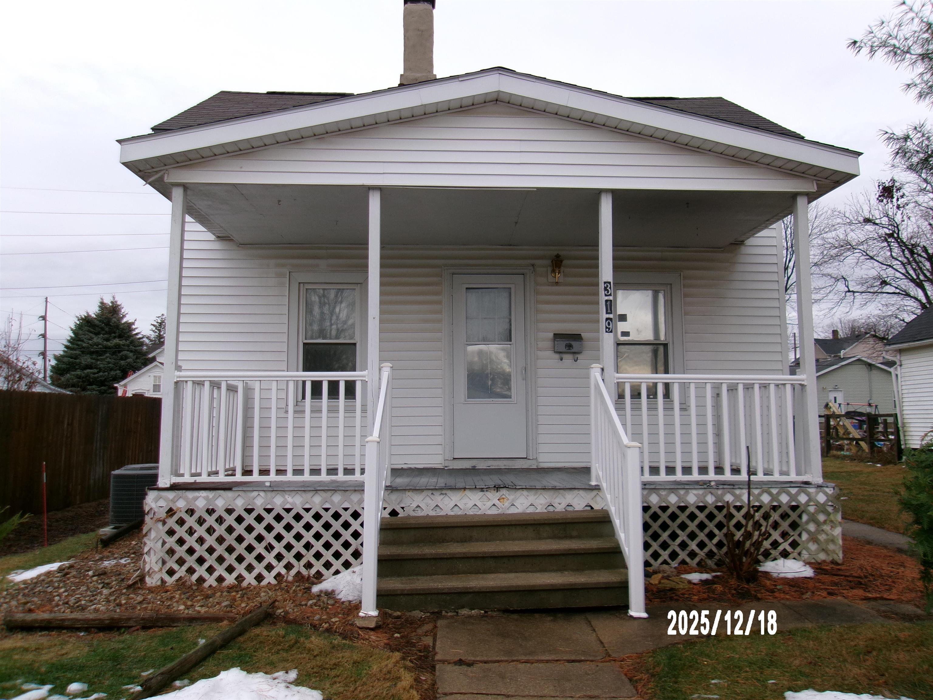 a front view of a house with a large window