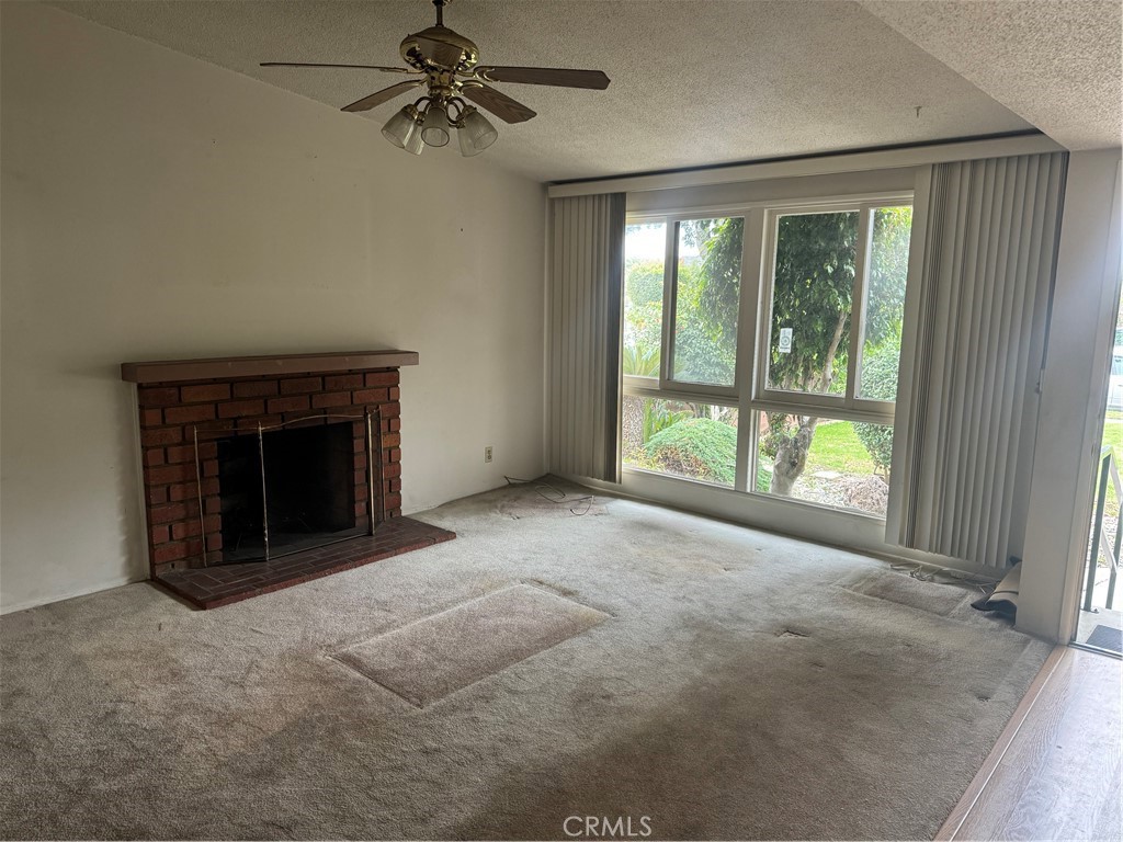 511 West 170th Street Gardena, CA 90248 - Photo 11 of 11 a view of an empty room with a fireplace and a window