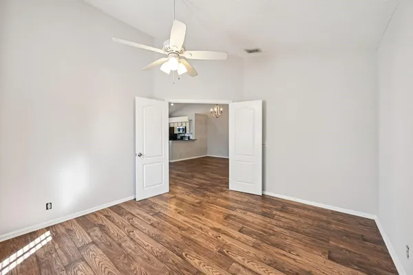 a view of a room with wooden floor