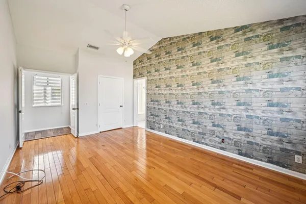 a view of empty room with wooden floor