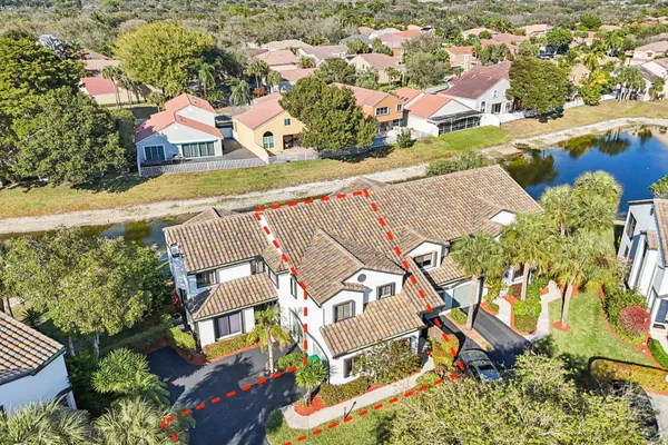 an aerial view of residential houses with outdoor space and swimming pool