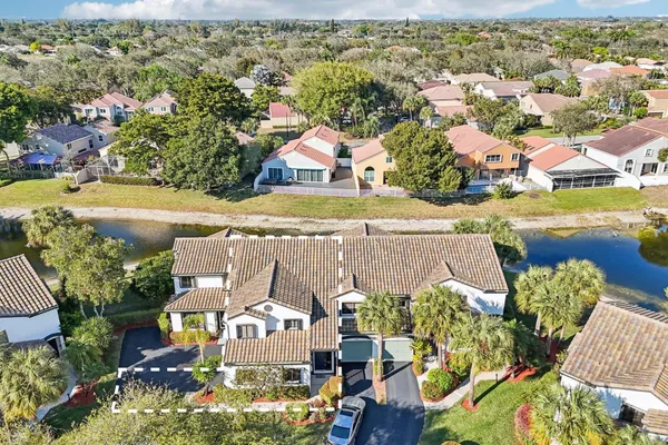 an aerial view of residential houses with outdoor space and swimming pool