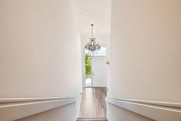 a view of an entryway with wooden floor