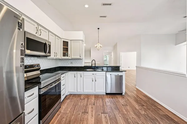 a kitchen with a sink microwave and refrigerator