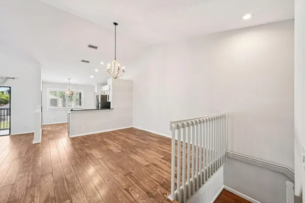 a view of a kitchen with wooden floor and a ceiling fan