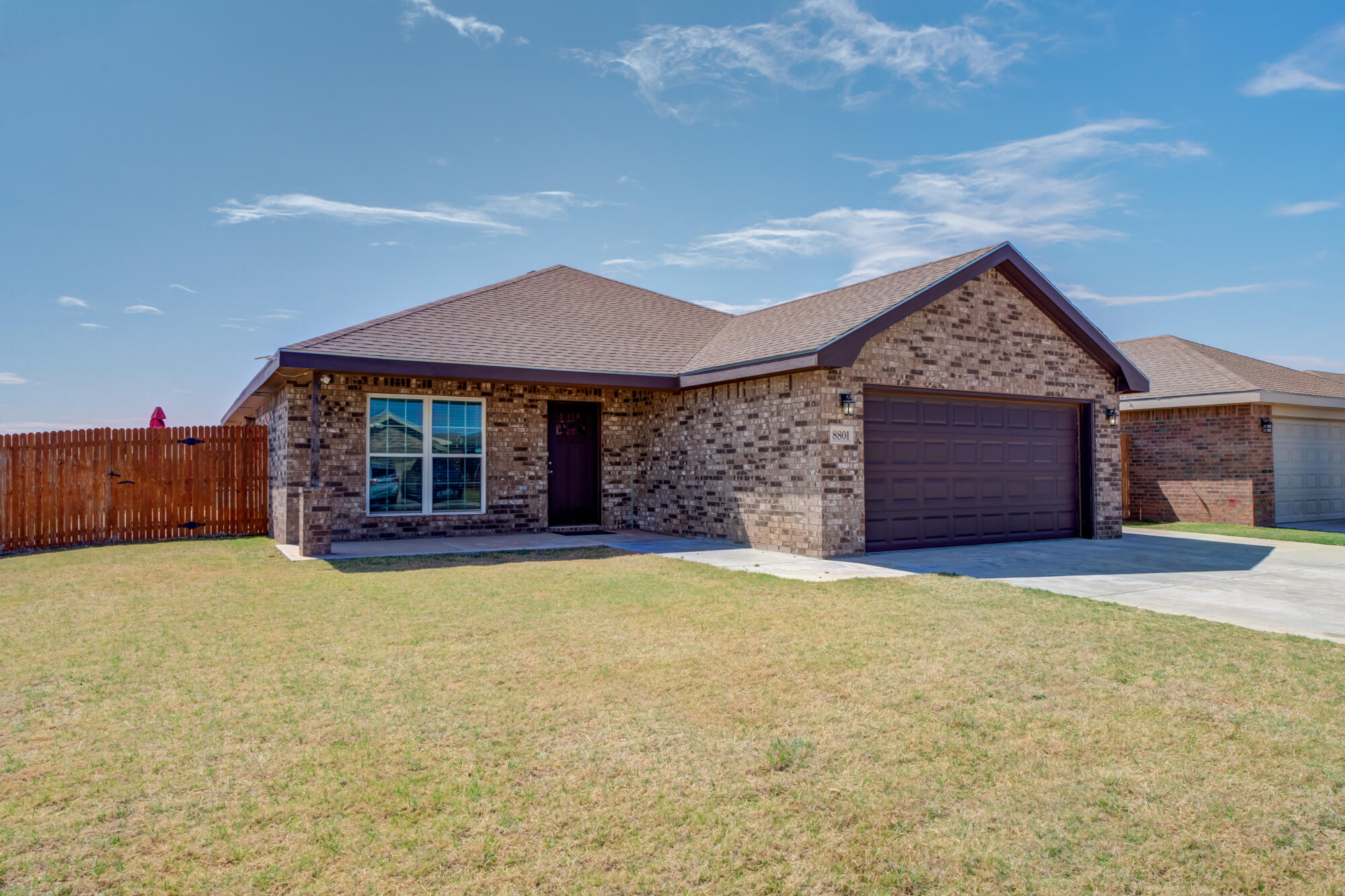 a view of a house with a yard and garage