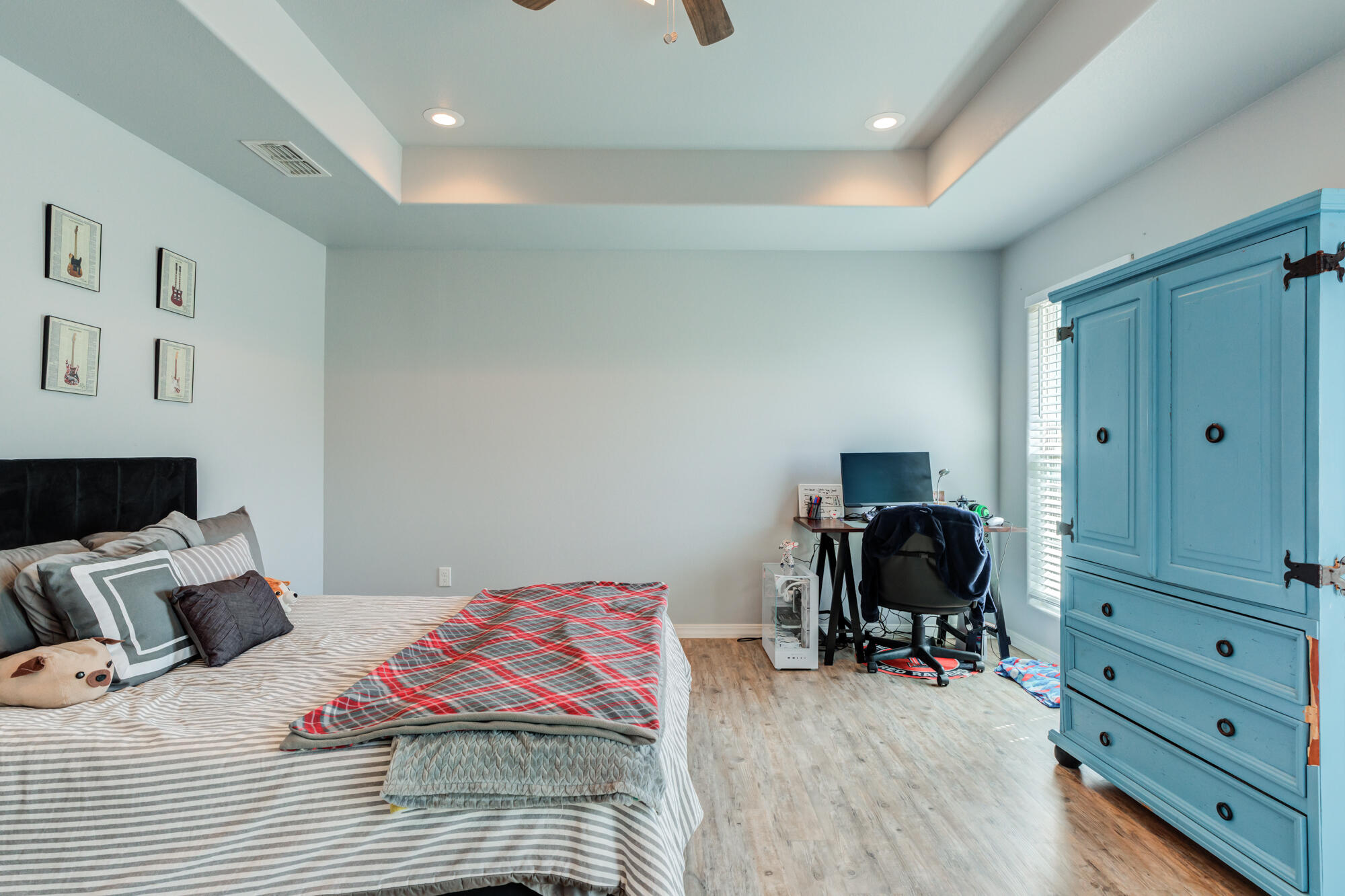 8801 15th Street Lubbock, TX 79416 - Photo 12 of 32 a bedroom with a bed and a chair