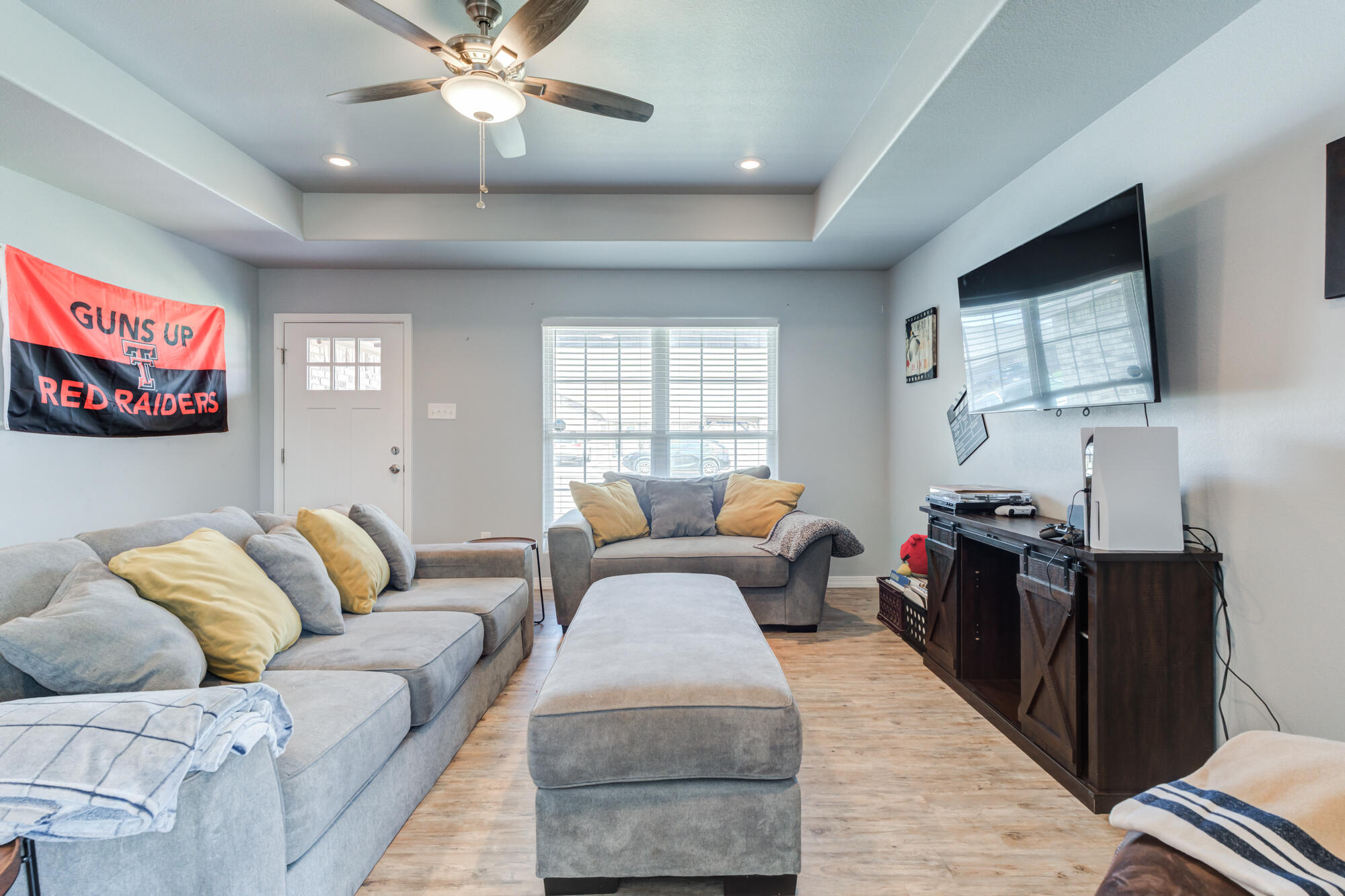 8801 15th Street Lubbock, TX 79416 - Photo 29 of 32 a living room with furniture and a flat screen tv