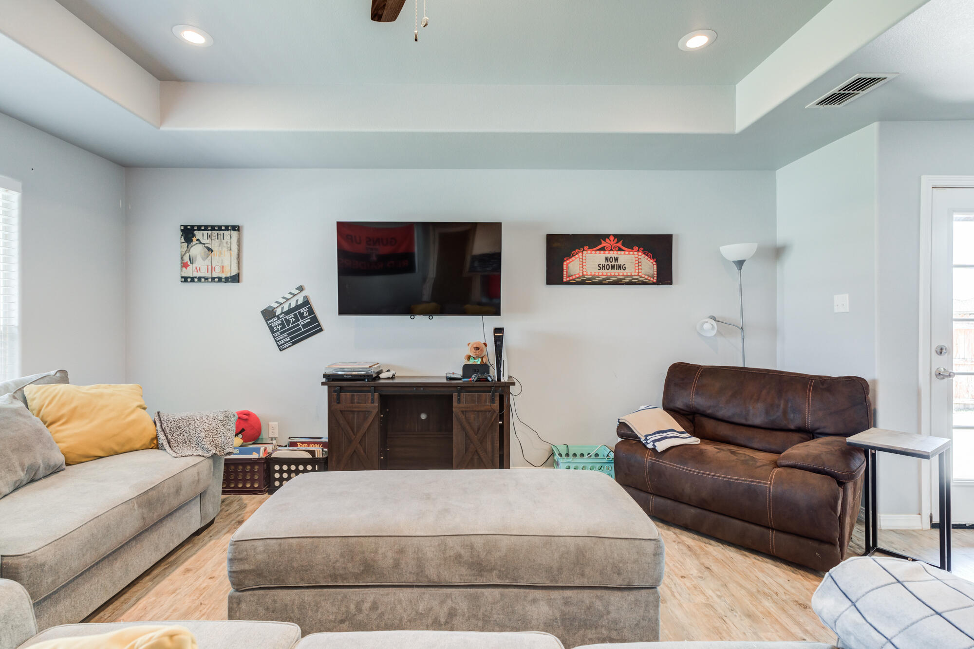 8801 15th Street Lubbock, TX 79416 - Photo 31 of 32 a living room with furniture and a flat screen tv