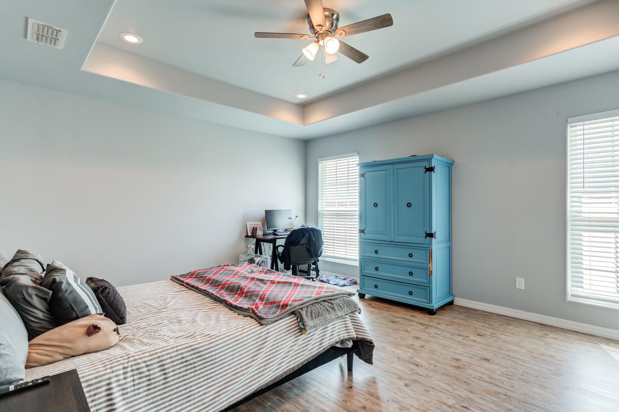 8801 15th Street Lubbock, TX 79416 - Photo 9 of 32 a bedroom with a bed and a ceiling fan