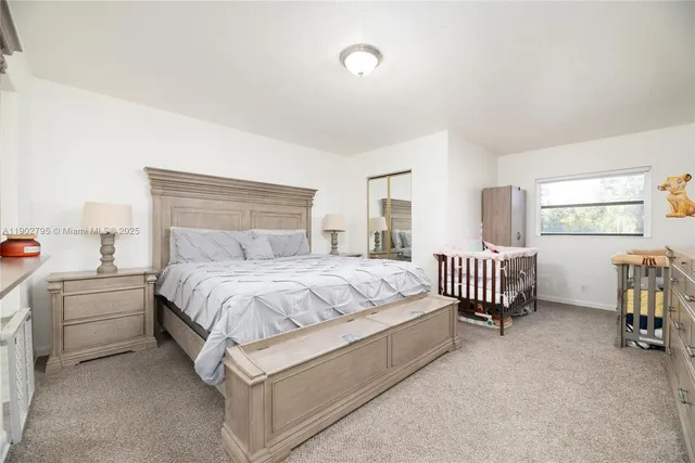 a spacious bedroom with a bed and a window