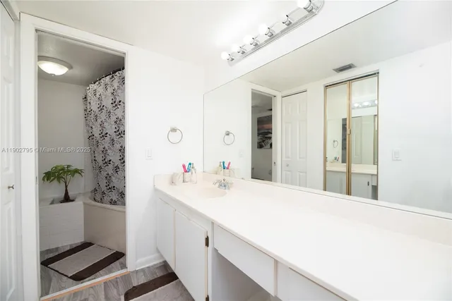 a bathroom with a double vanity sink and shower