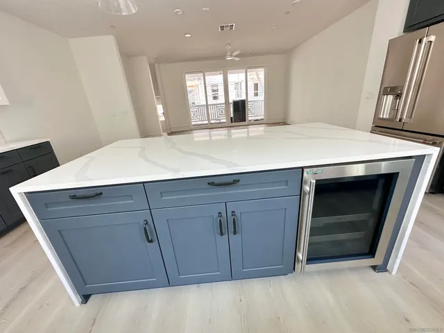 a room with a cabinets and a ceiling fan