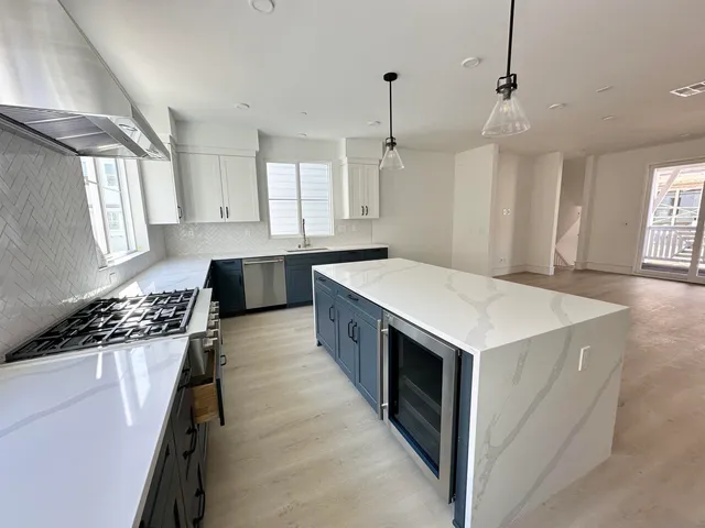 a kitchen with a stove sink and cabinets