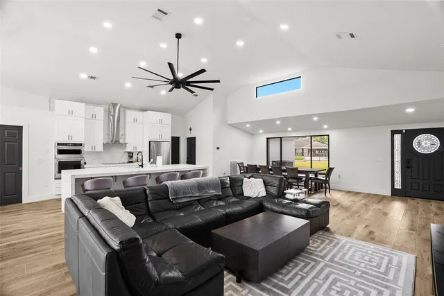 a kitchen with granite countertop white cabinets and stainless steel appliances