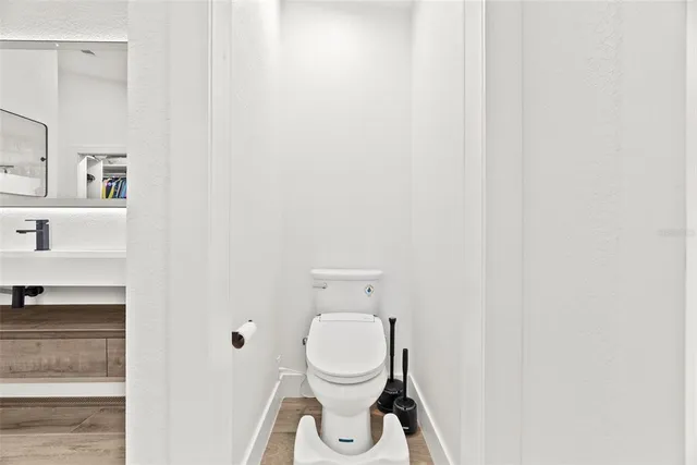 a view of a livingroom with furniture a flat screen tv and a floor to ceiling window