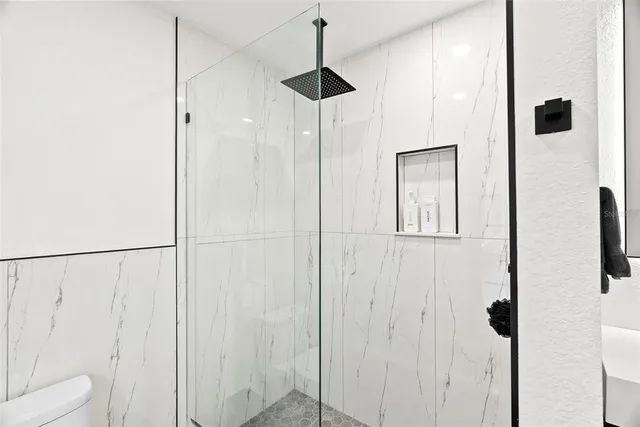 a view of a white house with a big yard and large trees