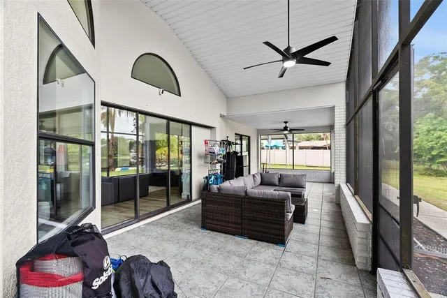 a view of a house with backyard and sitting area