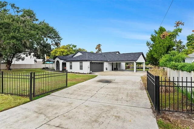 an aerial view of a house with a garden and swimming pool
