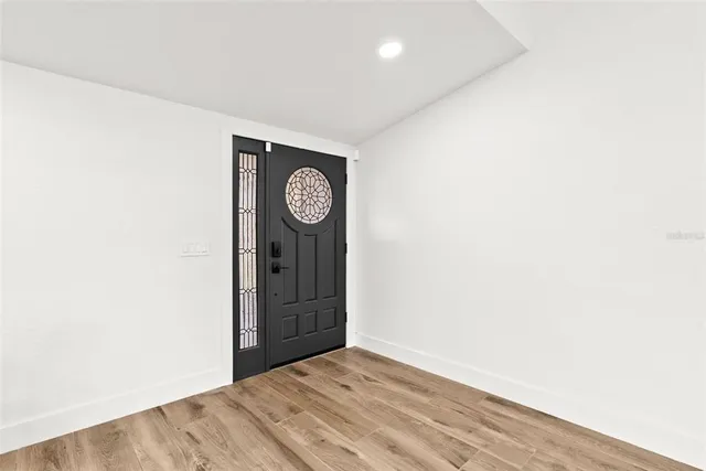 a living room with furniture flat screen tv and a large window