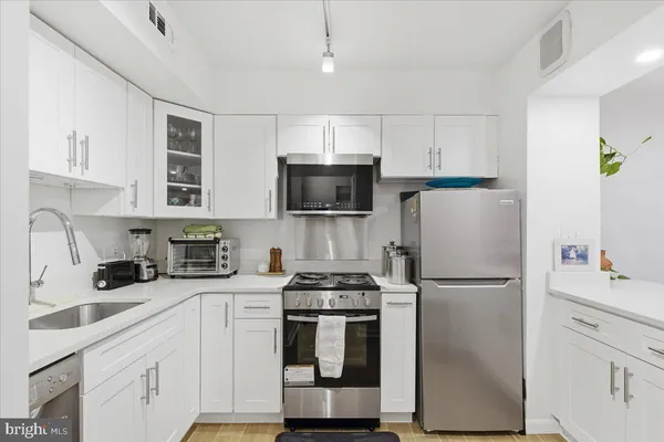 a kitchen with a refrigerator sink and microwave