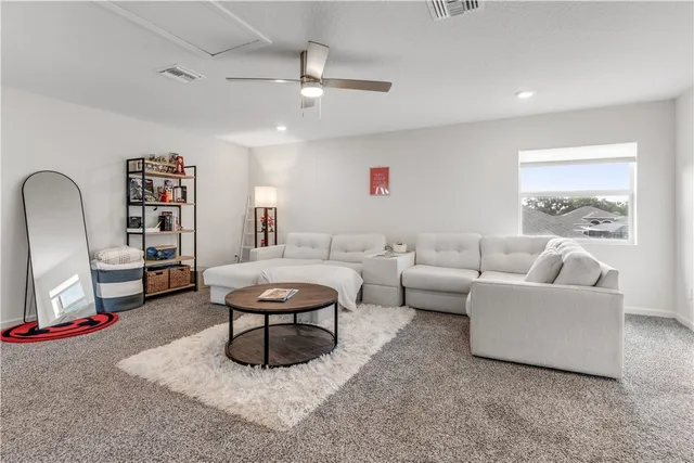 a living room with furniture and a rug