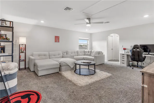 a living room with furniture a rug and a chandelier