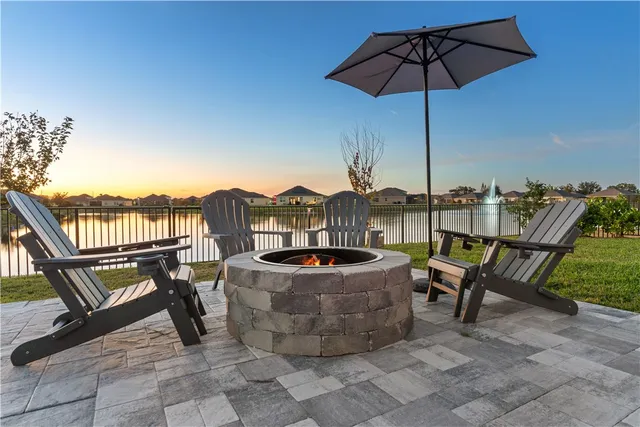 a view of a terrace with furniture and umbrella