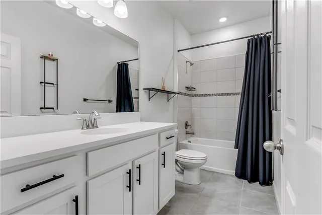 a bathroom with a double vanity sink toilet and shower