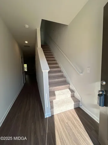 a view of entryway and hall with wooden floor