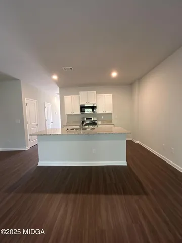 a view of kitchen with microwave and cabinets