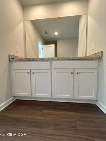 a view of granite countertop room with wooden floors